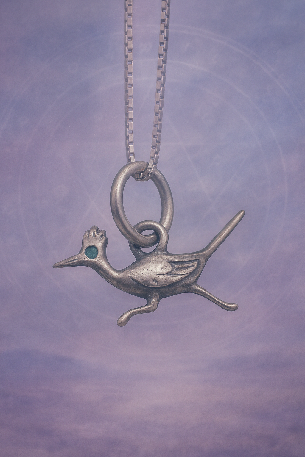Sterling silver roadrunner pendant with turquoise eye on chain, symbol of swiftness and spirit guidance.