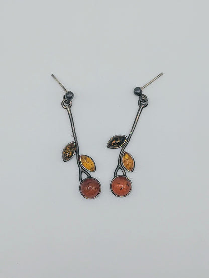 Pair of sterling silver vine earrings with round and marquise Baltic amber stones in three warm tones.