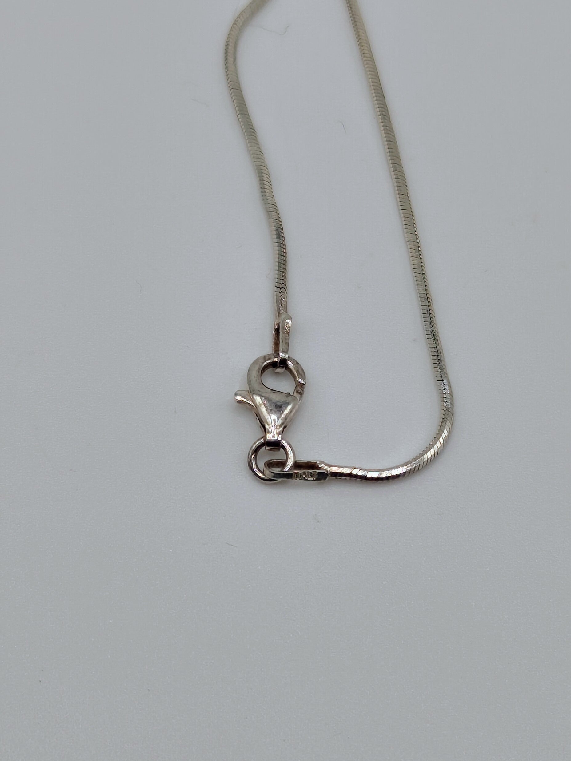 Sterling silver snake chain with clasp.