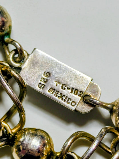 Sterling silver necklace composed of polished round beads alternating with open spiral-cage links, marked "MEXICO 925 TC 102"