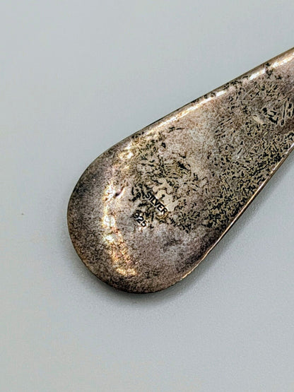 Pair of long sterling silver teardrop dangle earrings with geometric inlay of turquoise, coral, onyx, and mother-of-pearl.