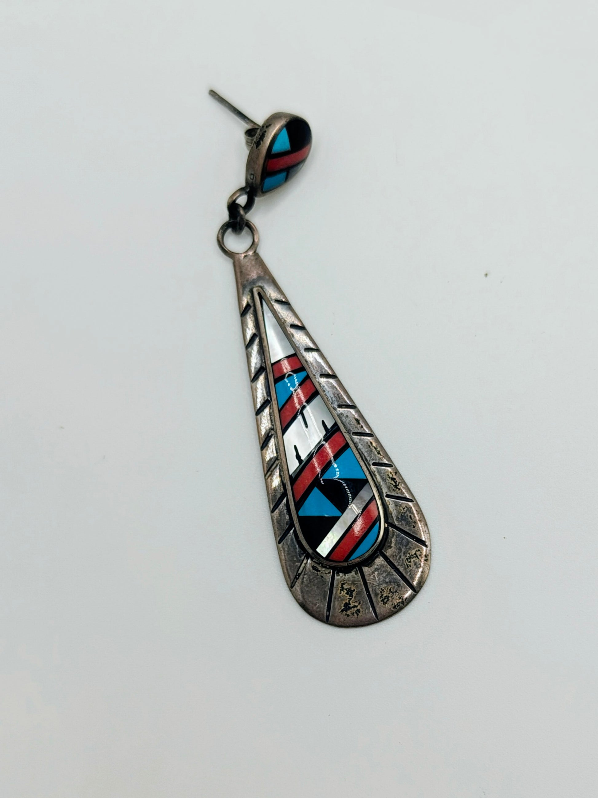 A single sterling silver teardrop dangle earrings with geometric inlay of turquoise, coral, onyx, and mother-of-pearl.