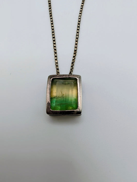 Sterling silver necklace featuring a rectangular bezel-set fluorite stone that fades from honey yellow to mossy green, hanging from an 18-inch box chain