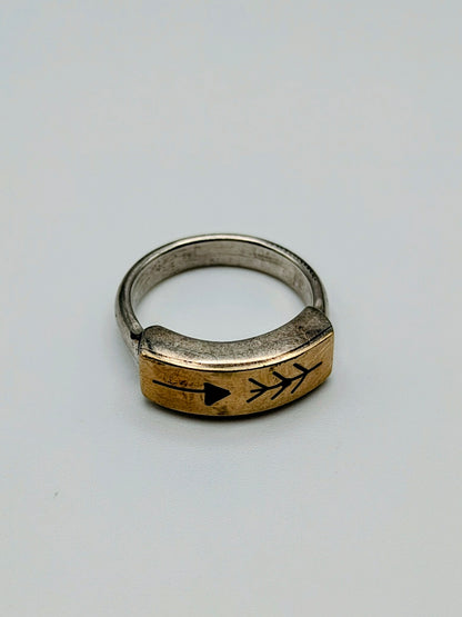 Sterling silver and 14k gold ring featuring an engraved arrow and feather design, with a white background.