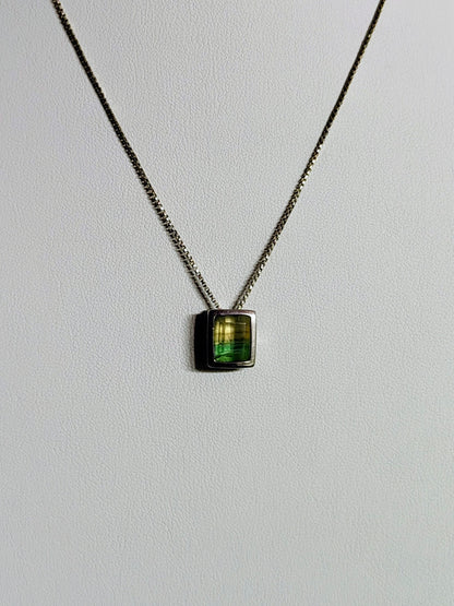 Sterling silver necklace featuring a rectangular bezel-set fluorite stone that fades from honey yellow to mossy green, hanging from an 18-inch box chain