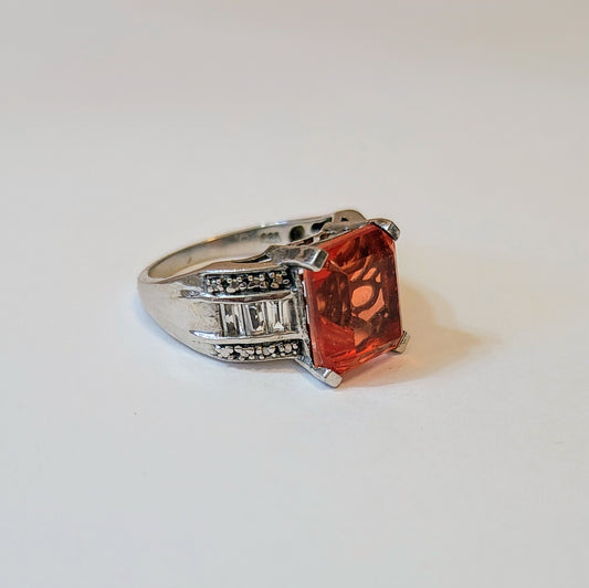 Side view of the Spinel Sunlight Ring showing an emerald-cut orange spinel set in sterling silver with diamond-accents