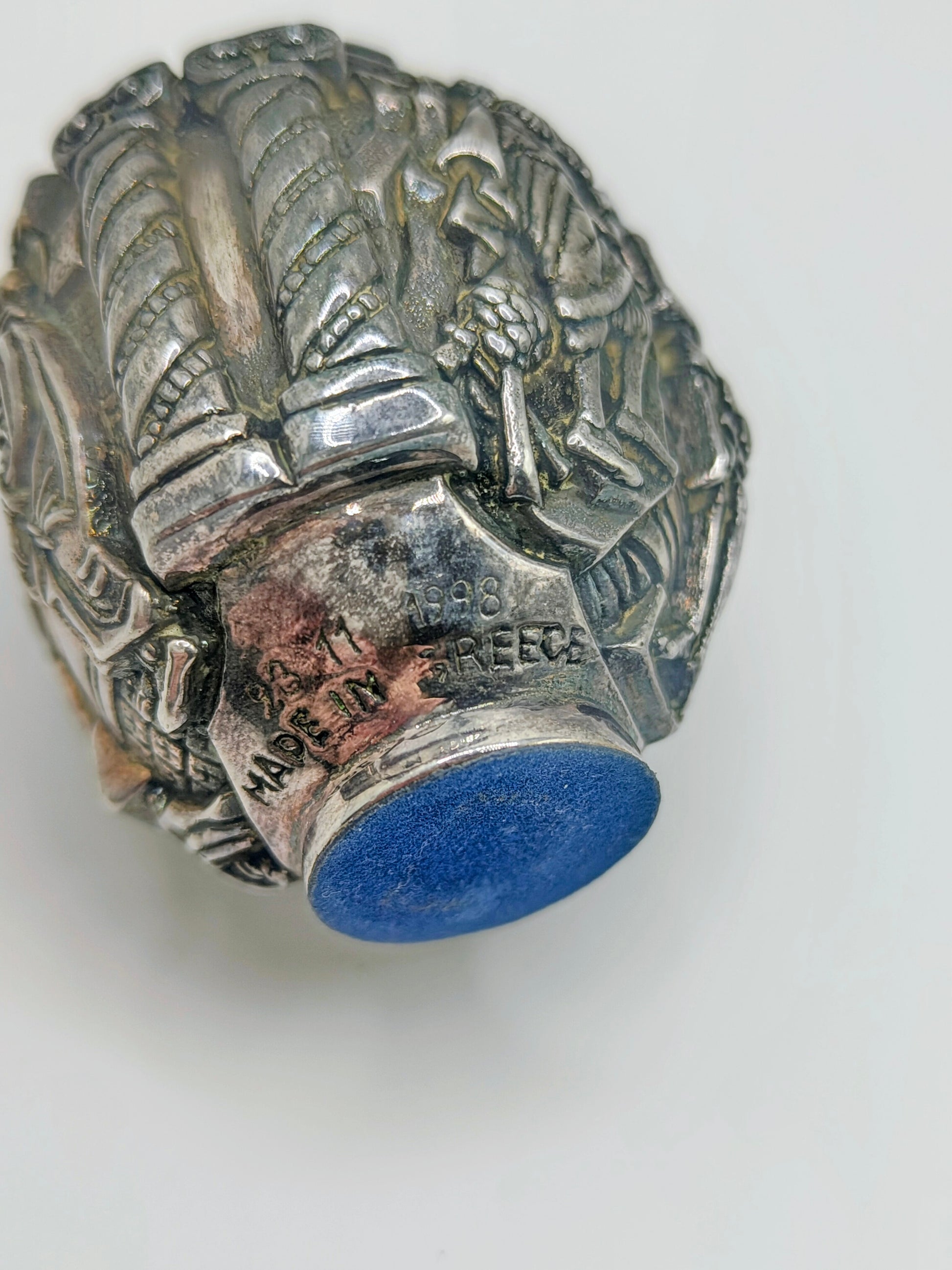 Palm-sized fine silver egg from Greece, richly carved with raised religious icon scenes and darkened recesses.