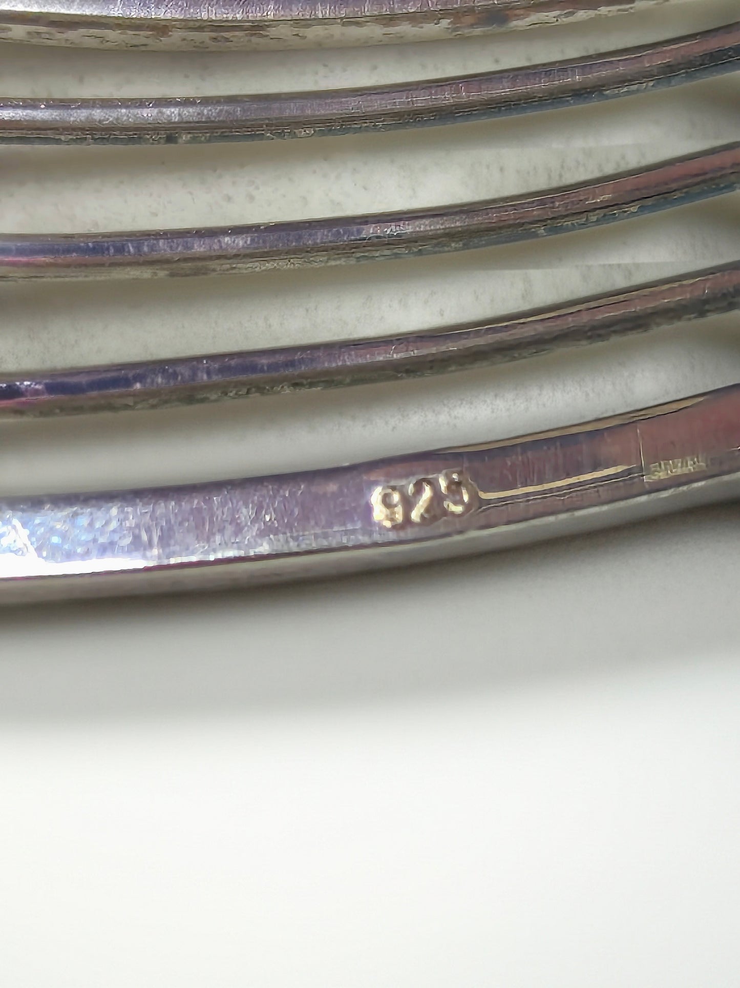 Close-up of the inside of the Abacus of Thresholds sterling silver cuff showing the 925 hallmark on the metal.