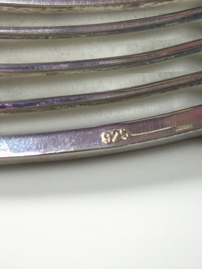 Close-up of the inside of the Abacus of Thresholds sterling silver cuff showing the 925 hallmark on the metal.