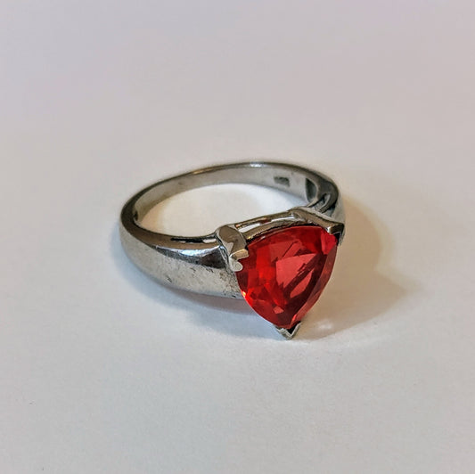 Sterling silver ring featuring a bright triangular-cut red spinel gemstone, displayed on a light background.