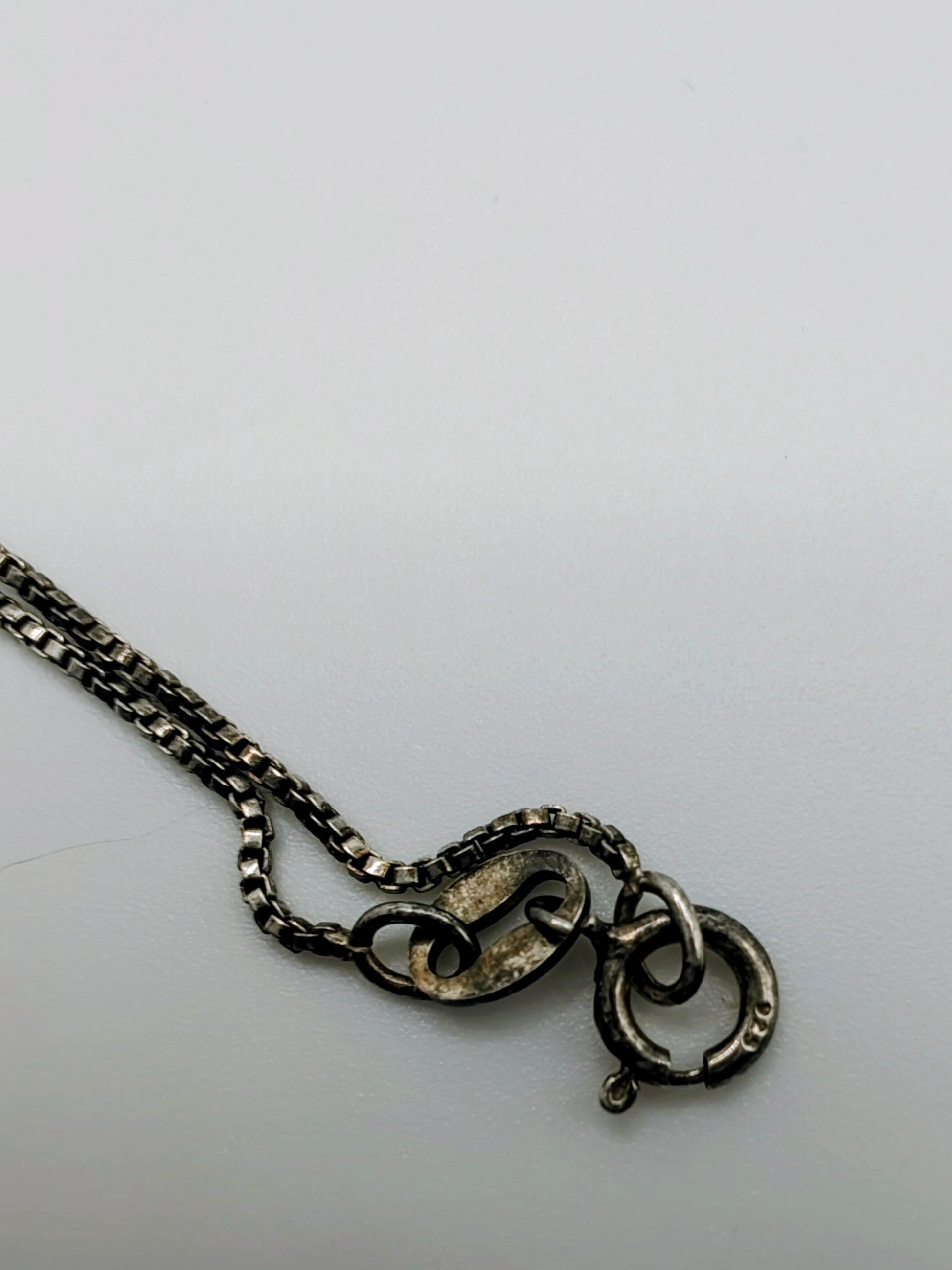 A delicate silver box chain.