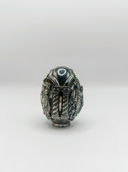 Palm-sized fine silver egg from Greece, richly carved with raised religious icon scenes and darkened recesses.