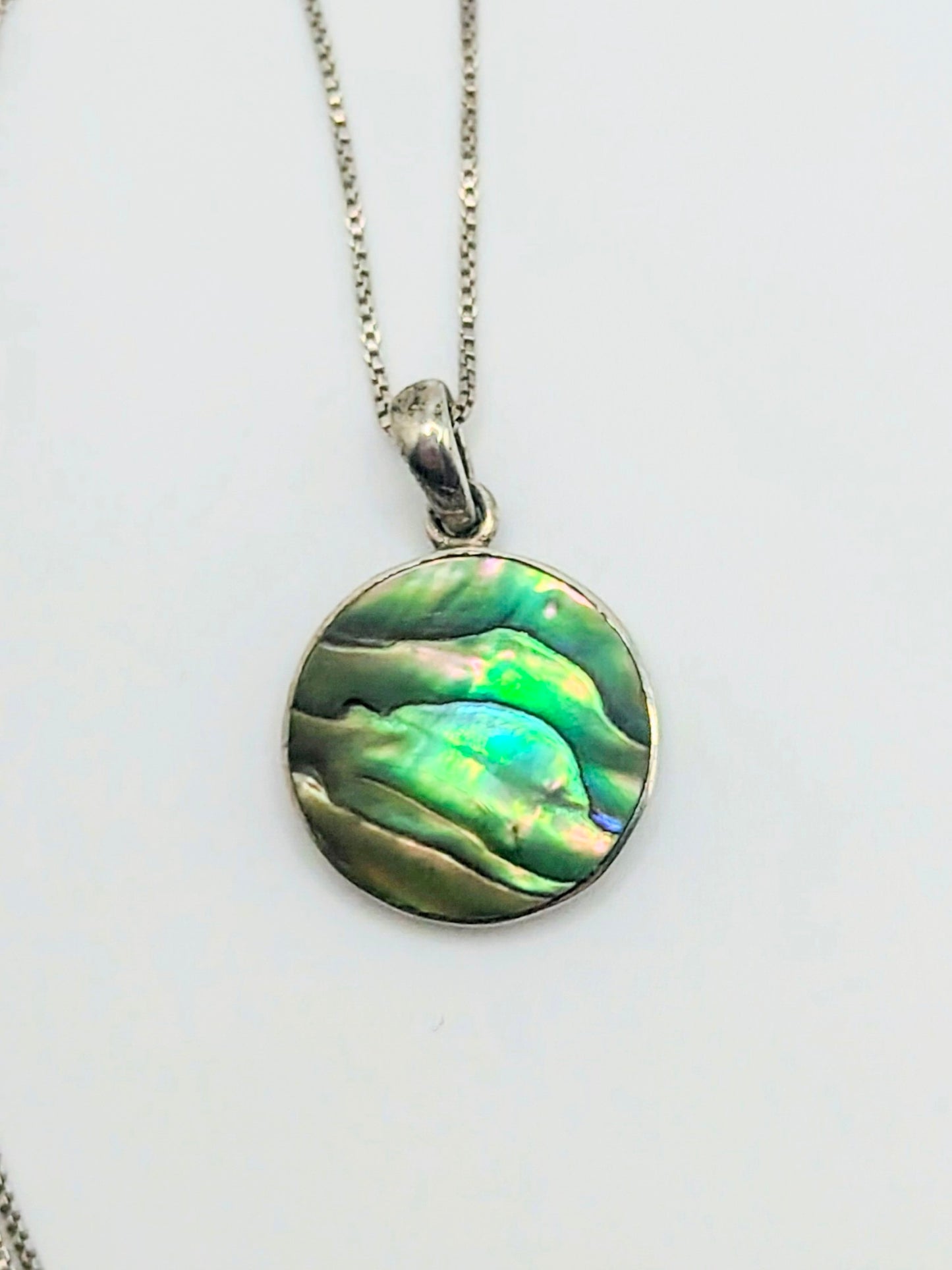 Sterling silver Tree of Life pendant with iridescent green and blue abalone shell inlay, with a delicate silver box chain.