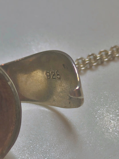 Sterling silver orb locket necklace closed, showing smooth round pendant with 925 marked.